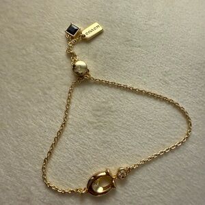 Coach Gold Bracelet with Pearl and Black Charm
